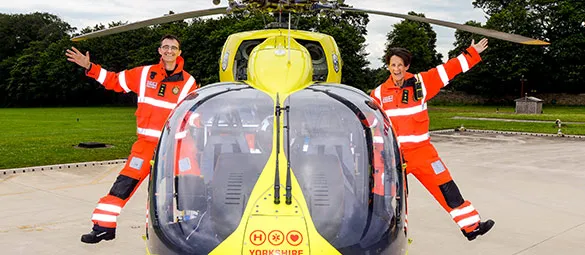 Crew leaning out of the helicopter