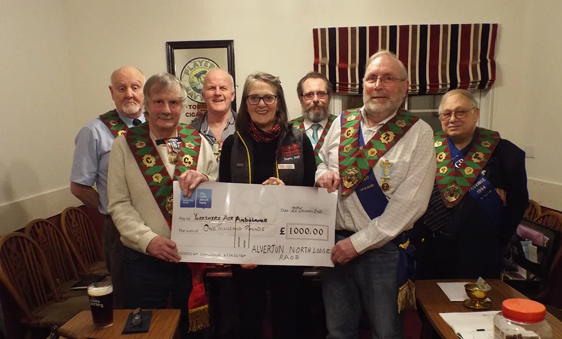 Members of Royal Antidiluvian Order of Buffaloes - Alverton Lodge are presenting Lin Stead from Yorkshire Air Ambulance with a cheque for £1000