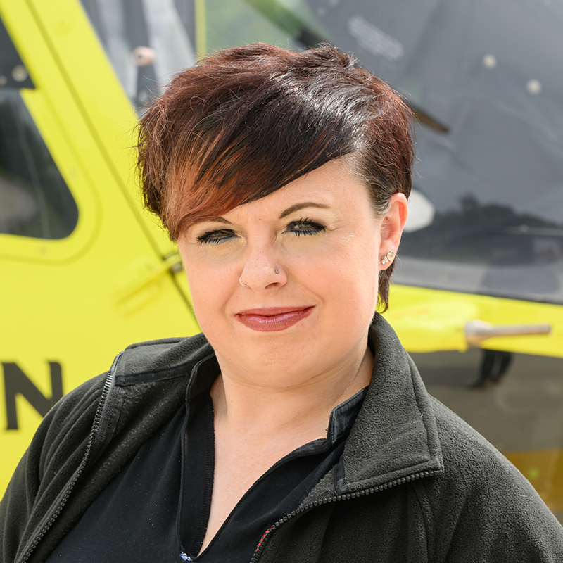 YAA West Community Fundraiser stood in front of one of the yellow Yorkshire Air Ambulance helicopters
