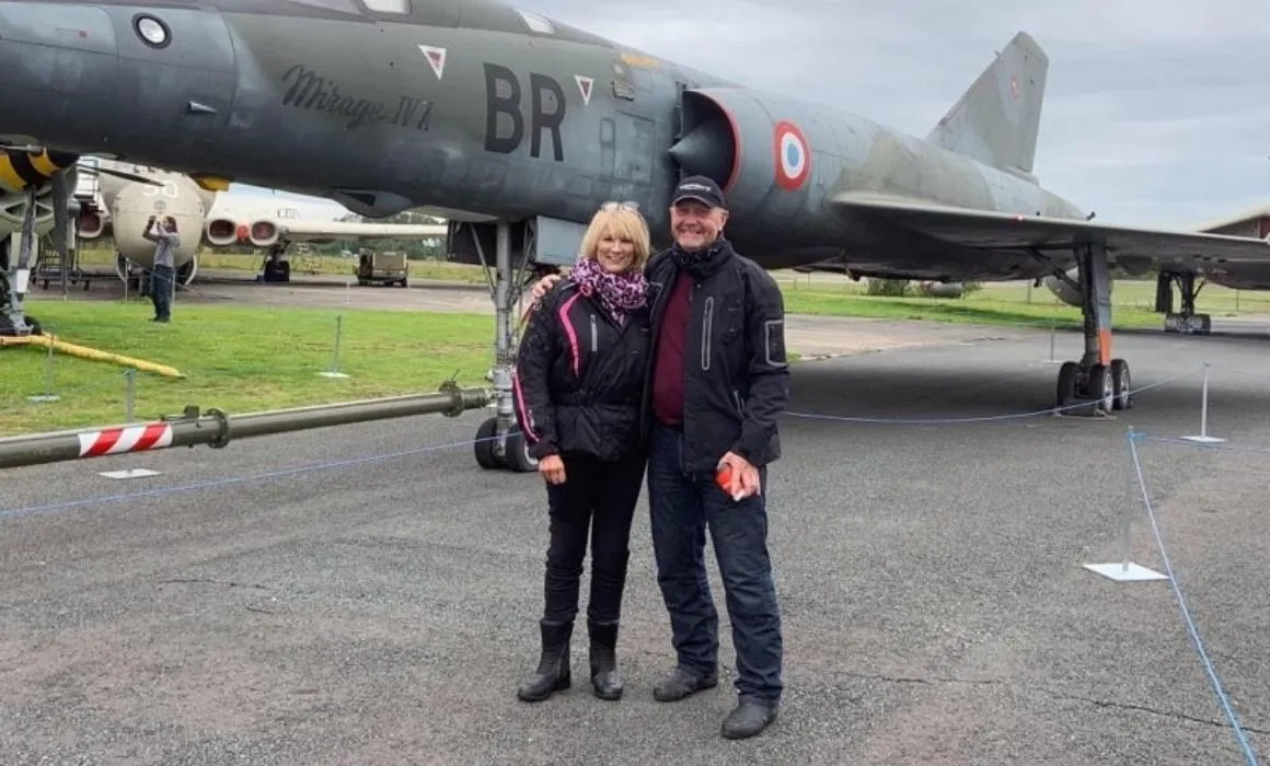 Gill and Dave Horn stand in front of an old military aircraft