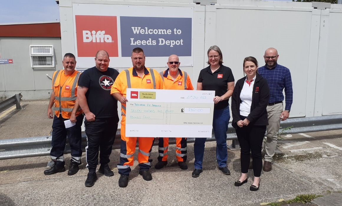 Group holding a big cheque