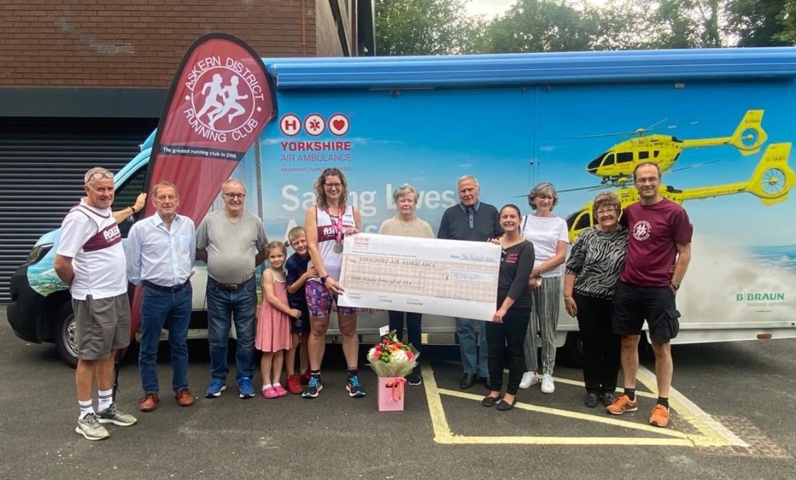 People holding a giant cheque